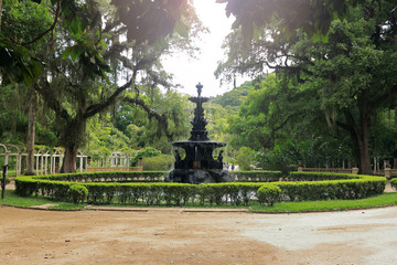 Beautiful fountain in the botanical garden of Rio de Janeiro, Brazil. Surrounded by many trees and vegetation.