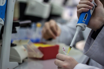 Modern scientist working in biotechnological laboratory equipmen