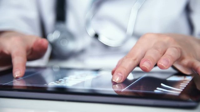 Doctor Hands Examines An X-ray Of Patient On Digital Tablet. Slow Motion Effect