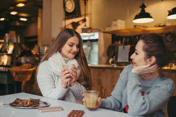 two girls driking coffee in cafe
