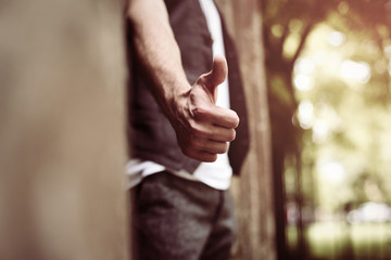 Hand with thumb up.