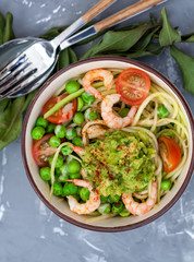 Zucchini pasta with shrimps and avocado in the bowl. Love for a healthy food concept