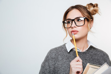 Close up portrait of woman with books and pencil