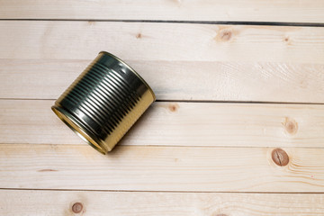 Tin cans for food on wooden background