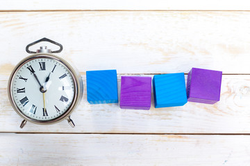 alarm clocks on wooden table
