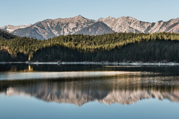 Fototapeta premium Winter landscape with lake and mountains, Zugspitze, Aibsee, Germany