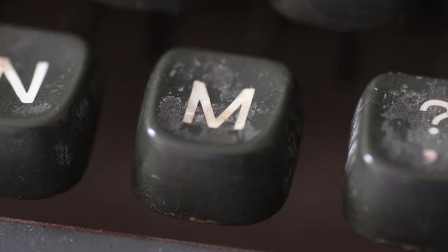 Macro shot on the letter M key typed on an old vintage typewriter machine