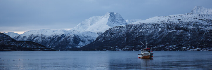 Fototapeta premium Boat in a winter fjord, Norway