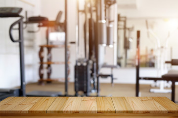  Product display montage Concept. Empty wood table space platform and fitness gym background.