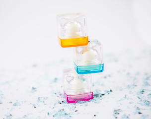 Glossy cosmetics containers stacked on each other