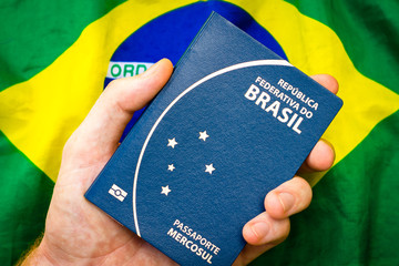 Male holding hand in Brazilian passport