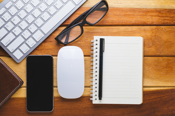 Office desk wood with computer, note book,phone concept in wood background.Copy space.