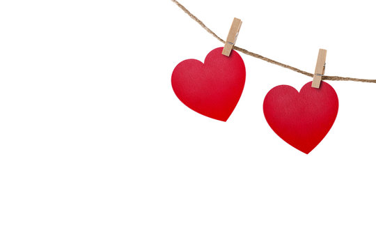 Love hearts hanging on rope on white with clipping path