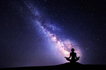 Foto op Plexiglas Milky Way and silhouette of a woman practicing yoga. © den-belitsky