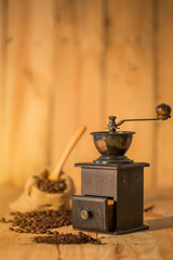 Manual coffee grinder and  coffee bean on  wooden surface