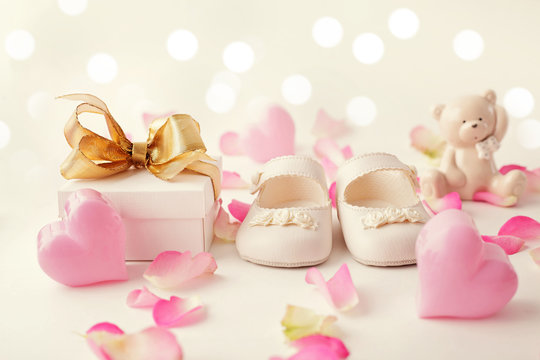 baby shoes, flowers and gift box
