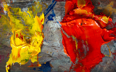 Yellow and orange paints being mixed