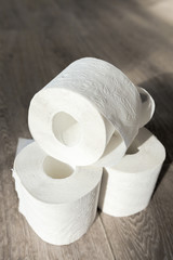Toilet paper on wood background