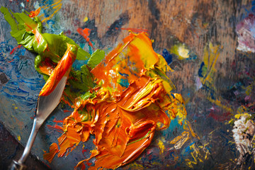 Top view of a putty knife and paints