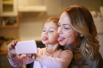Mother with daughter making funny face.