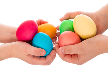 many easter eggs in two child hands
