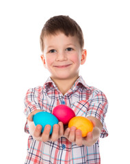Fototapeta na wymiar Smiling little boy showing painted easter eggs