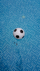 Fototapeta na wymiar Inflatable ball floating in swimming pool