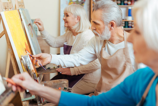 Three professional artists spending time in painting studio