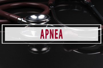 Obraz premium Stethoscope on black background with text APNEA