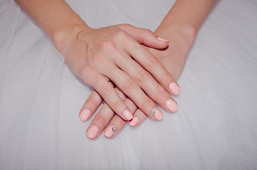 Beautiful bride's hands with a gentle nail polish
