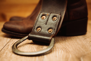 Pair of cowboy boots and leather belt