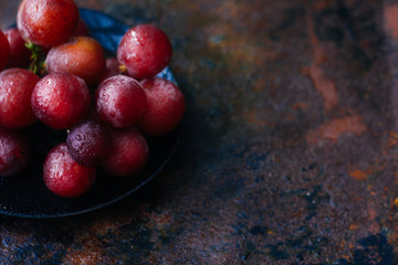 Bunch of grapes on black plate