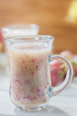 Grape smoothie over the white table.