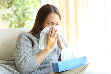 Woman blowing with flu in winter