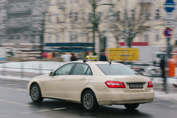 Fototapeta na wymiar Speeding taxi in city, intentional motion blur