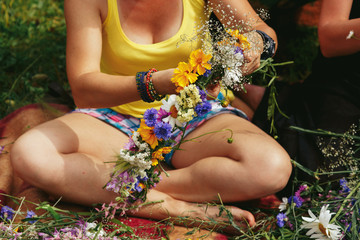 Young hipster women making flower wreaths circle closeup