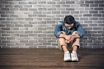 man sit on ground feel lonely