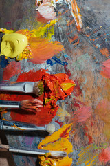 Top view of palette and painting brushes lying on it