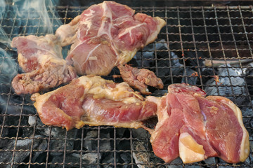 Meat on outdoor coal barbecue grill, selective focusing close-up