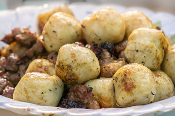 Grilled fishballs and meat on white plate, selective focusing cl