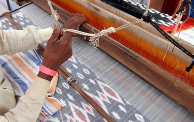 worker weaving hand loom Indian saree or sari,traditional woman dress
