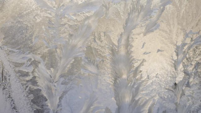 time lapse of ice patterns and snow melting on window
