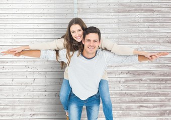 Man giving a piggyback ride to woman