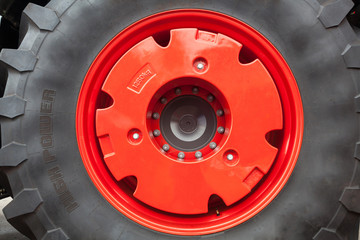 A fragment of a huge wheel and tire of construction equipment
