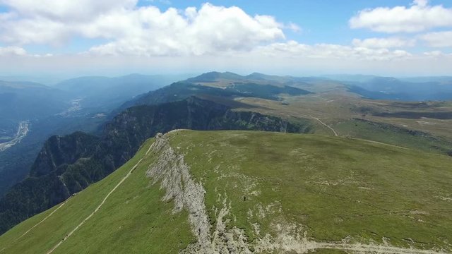 Turists enjoying the view from Caraiman Peak, Romania, aerial view