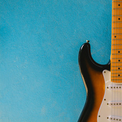 Vintage sunburst color guitar with blue cemennt background.