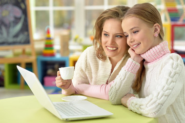 Mother and daughter with laptop