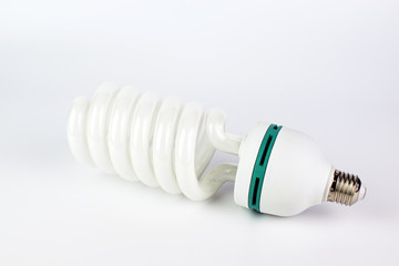 Energy saving light bulb with green line on a white background.