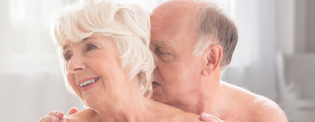 Senior man kissing his wife's neck