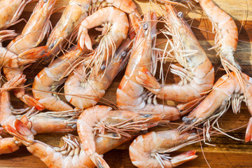 fresh raw shrimps in a bowl on a wooden table